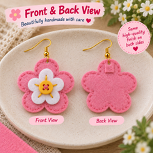 Front and back view of pink felt flower earrings showing white flower button centre and stitched back finish